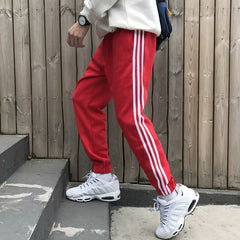 calça reta de esportes com 3 listras na perna unissex